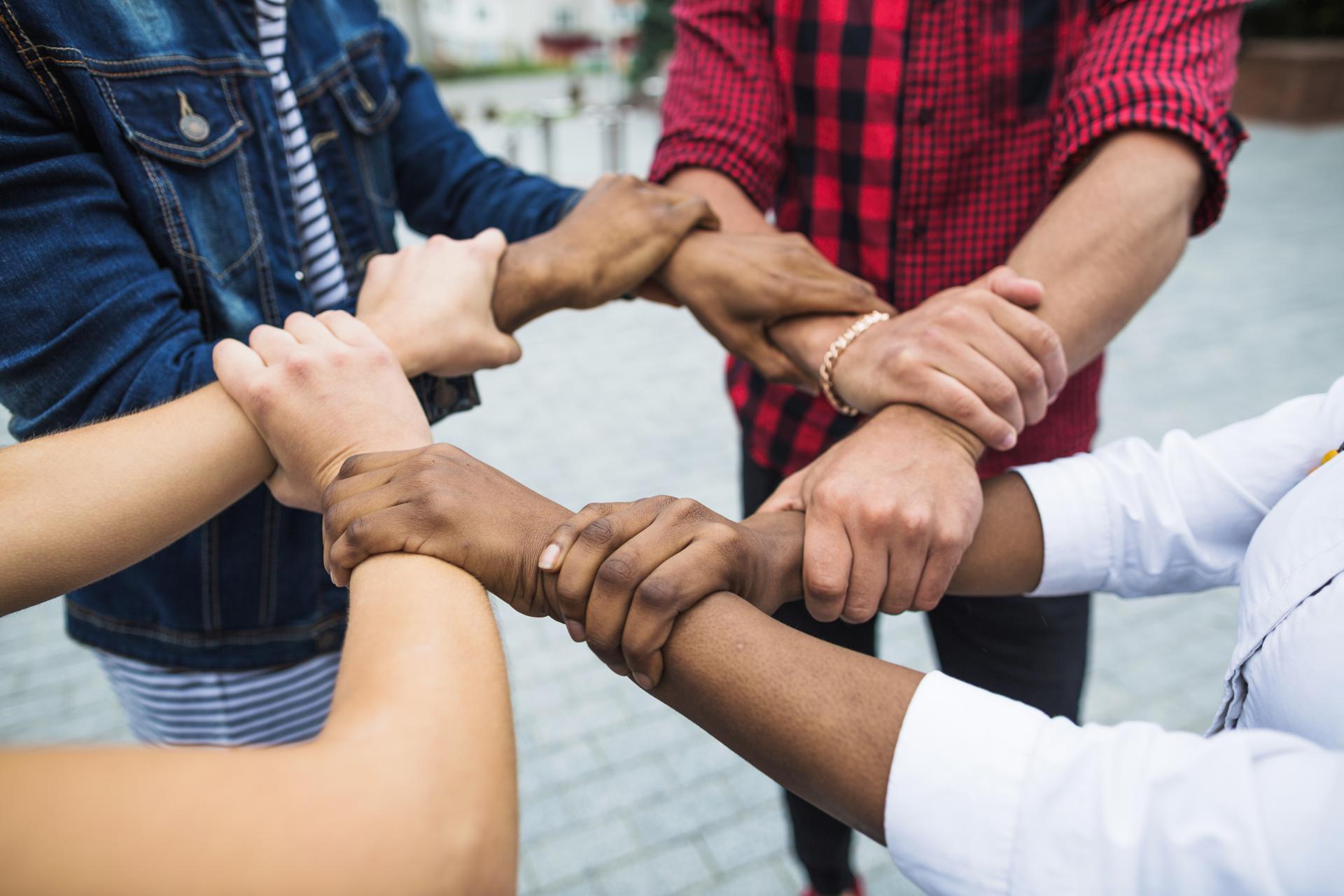 anonymous-multiracial-people-stacking-hands.jpg